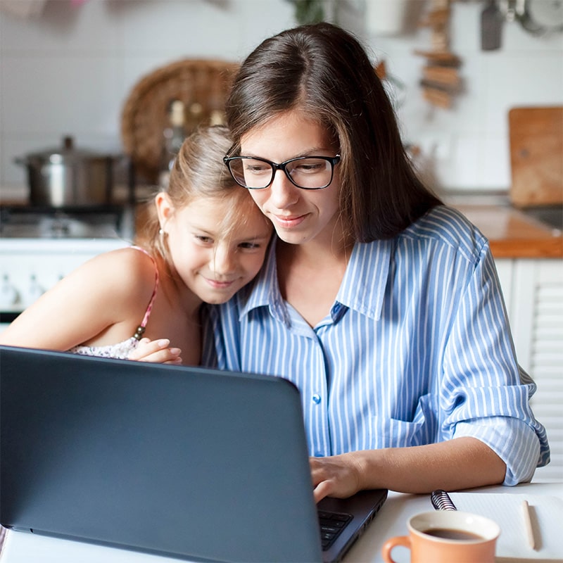 woman and her daughter looking at a laptop